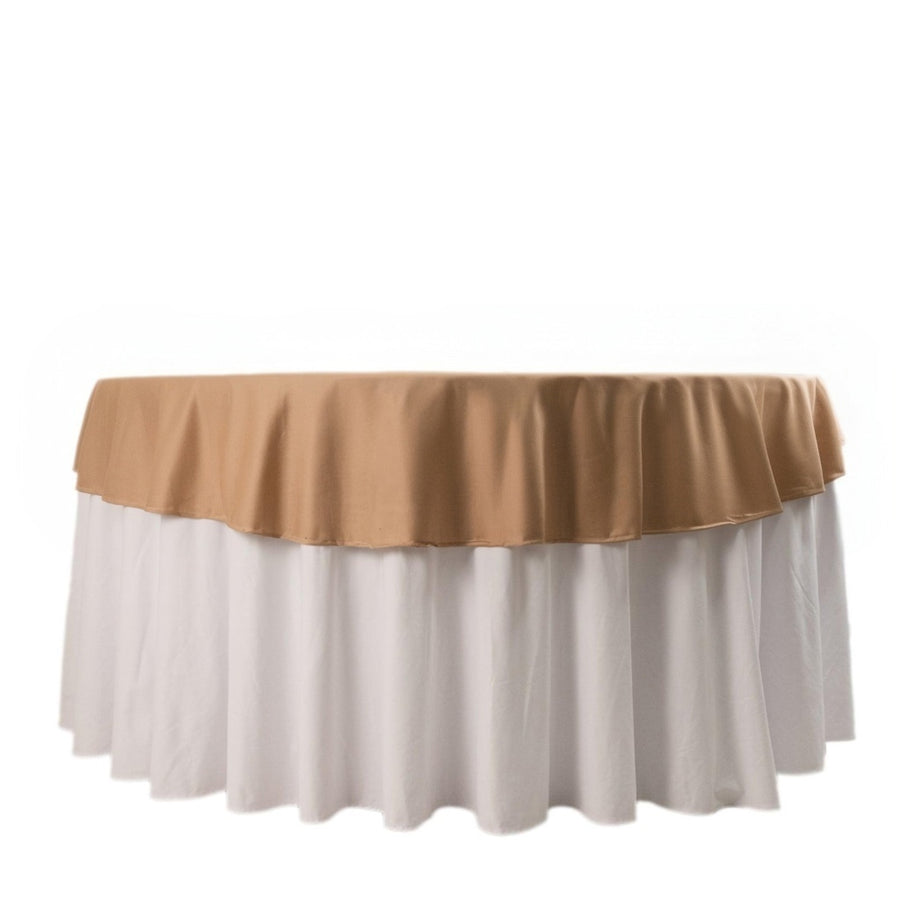 Round table with beige and white tablecloths in studio-style isolation shot