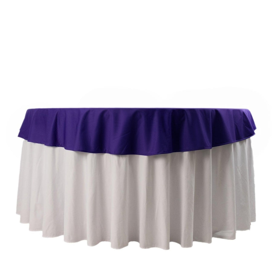 Purple and white tablecloth draped elegantly over a round table