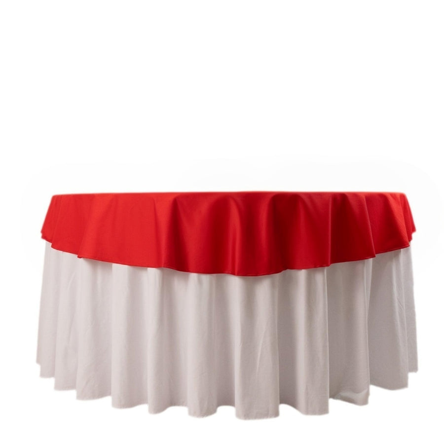 Red and white round tablecloth with a ruffled edge