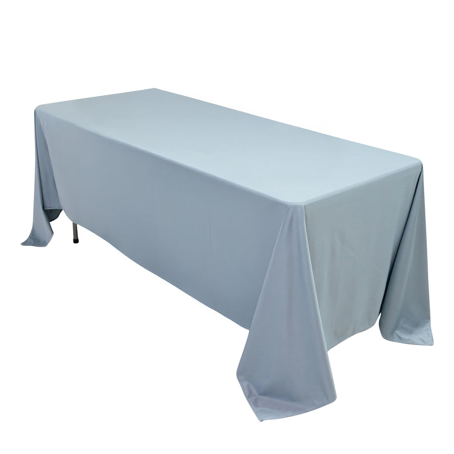 Gray tablecloth draped over a long table on a plain background