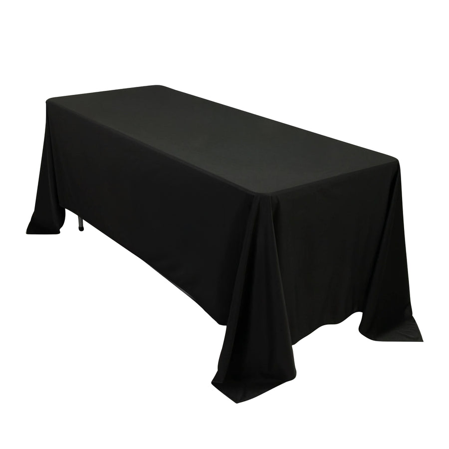 Black tablecloth draped over a rectangular table for events or dining.