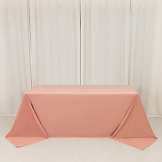 Pink tablecloth draped elegantly over a table in a studio setting.