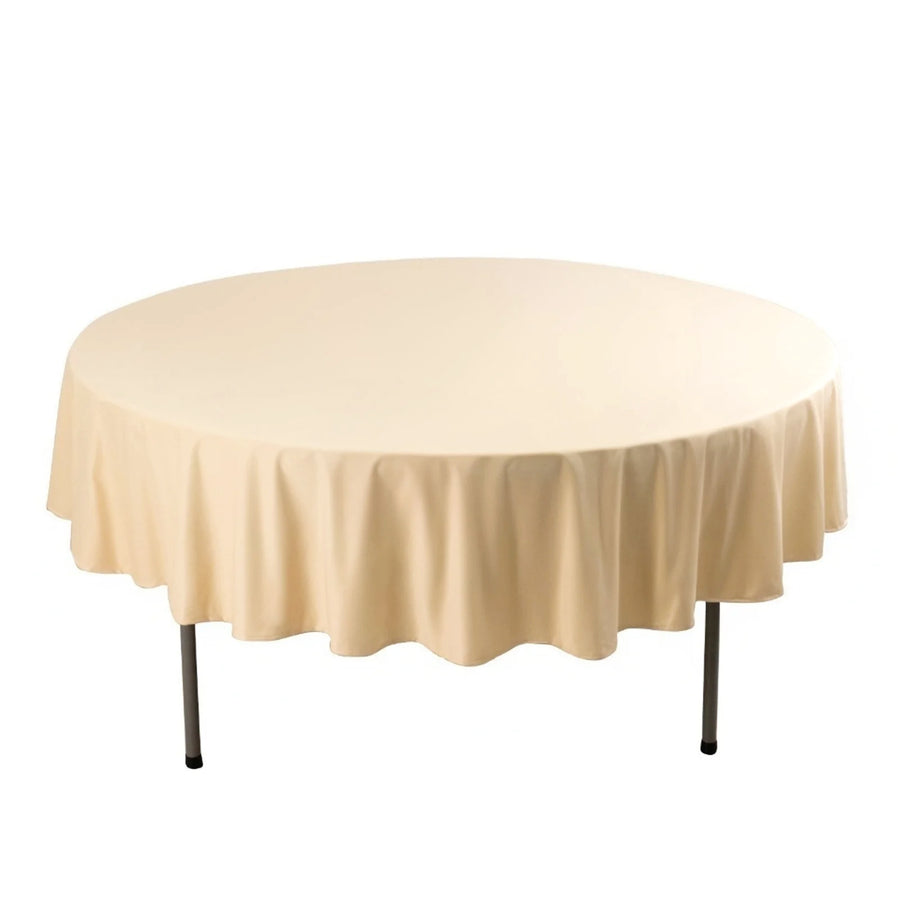 Round beige tablecloth draped over a table.