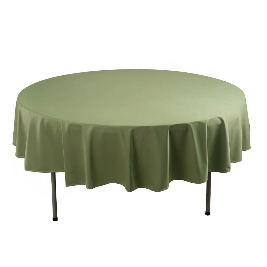 Round olive green tablecloth on a white table.