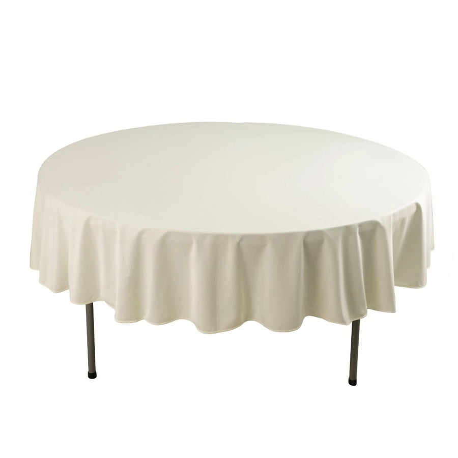 Round table with a white tablecloth on metal legs
