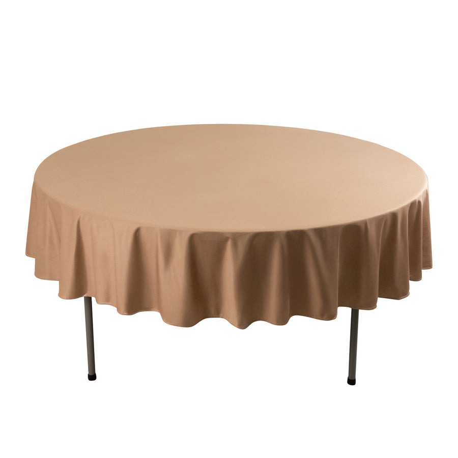 Round table with a beige tablecloth on metal legs