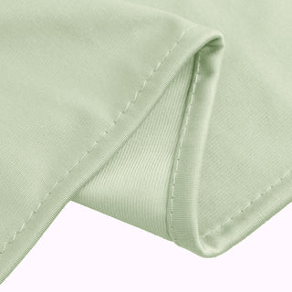 Green fabric showing detailed stitching and texture.
