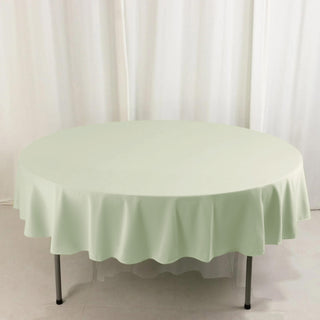 Round mint green tablecloth on a white backdrop