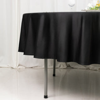 Black tablecloth draping elegantly over a table with a glossy surface.
