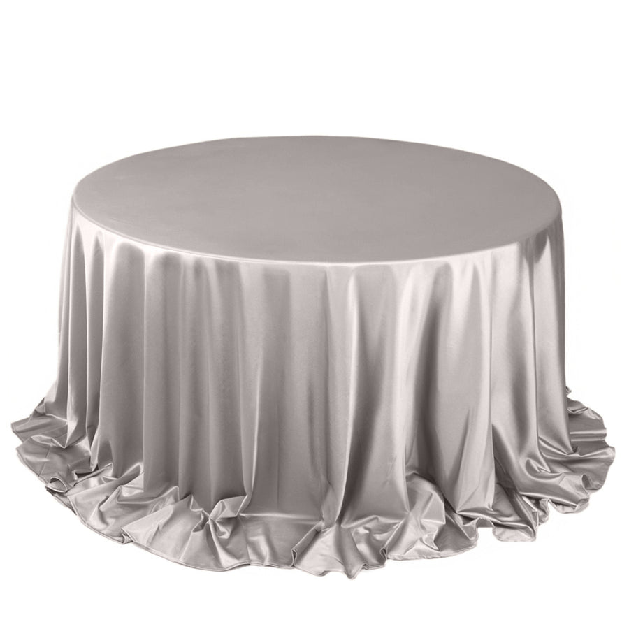 Silver round tablecloth with elegant draping and ruffles.