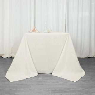Experience Luxury and Convenience with the Ivory 90"x90" Premium Polyester Square Tablecloth Experience Luxury and Convenience with the Ivory 90"x90" Premium Polyester Square Tablecloth