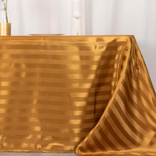 Elevate Your Event with the 90"x132" Gold Satin Stripe Seamless Rectangular Tablecloth Elevate Your Event with the 90"x132" Gold Satin Stripe Seamless Rectangular Tablecloth