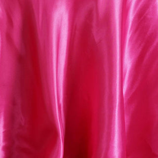 Vibrant pink satin fabric with smooth texture and sheen.
