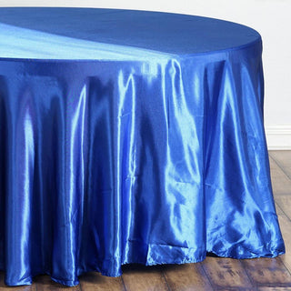 Blue satin tablecloth draped over a round table.