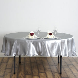 Add Elegance to Your Event with the 90" Silver Seamless Satin Round Tablecloth