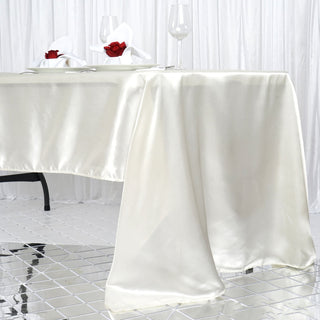 Elevate Your Event with the Ivory Seamless Satin Rectangular Tablecloth