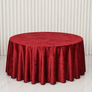 Red velvet round tablecloth on a large banquet table in a bright room
