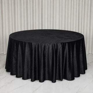 Round table with black velvet tablecloth in elegant event setting