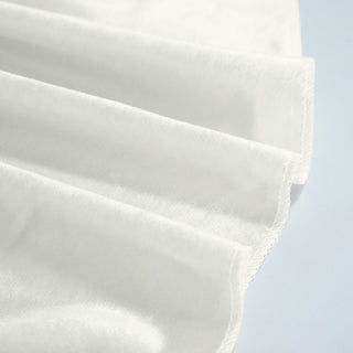 Close-up of white pleated face mask fabric with stitched edge