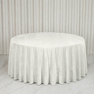 Round white tablecloth draped on a banquet table with matching backdrop