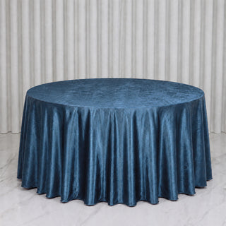 Round table with blue satin tablecloth in elegant event setting