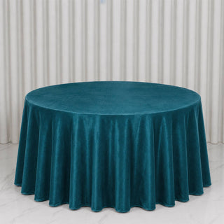 Teal round velvet tablecloth on elegant dining table backdrop