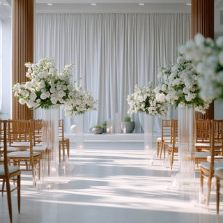 Elegant wedding ceremony setup with floral arrangements and chairs.