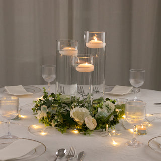 Elegant table centerpiece with candles and floral arrangement.