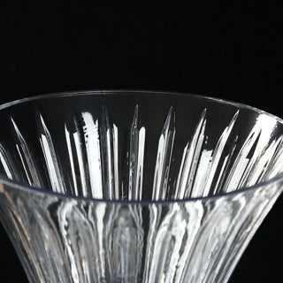 Close-up of a crystal glass bowl with faceted cut pattern on black background