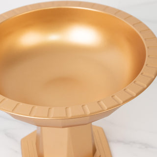 Gold bowl on a pedestal with a glossy finish.