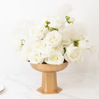 Elegant white rose arrangement in a gold pedestal vase.
