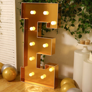 Gold marquee letter "E" with lights, perfect for events and celebrations.