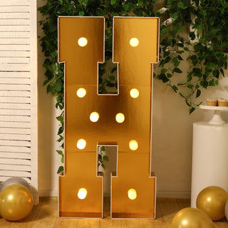 Gold letter "H" marquee sign with lights, perfect for events and celebrations.