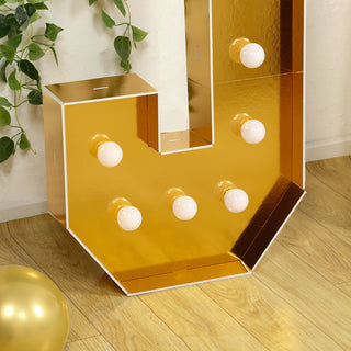 Gold marquee letter with bulbs, ideal for events and decor.