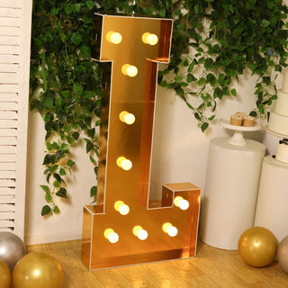 Gold marquee letter 'L' with lights, perfect for events or decor.