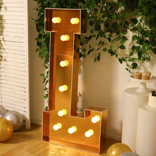 Giant illuminated letter "L" marquee light in gold finish, perfect for events.