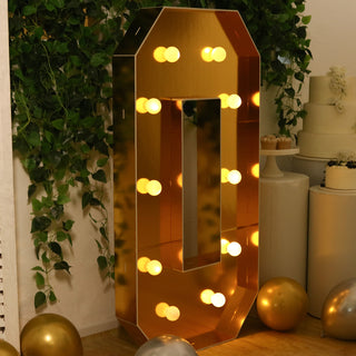 Gold marquee number "0" with lights, perfect for party decor.