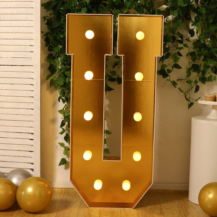 Gold marquee letter 'U' with lights, perfect for events and celebrations.