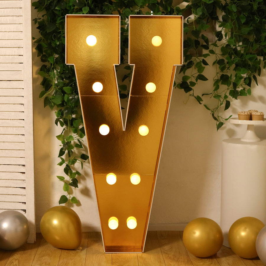 Gold marquee letter "V" with lights, perfect for events and celebrations.
