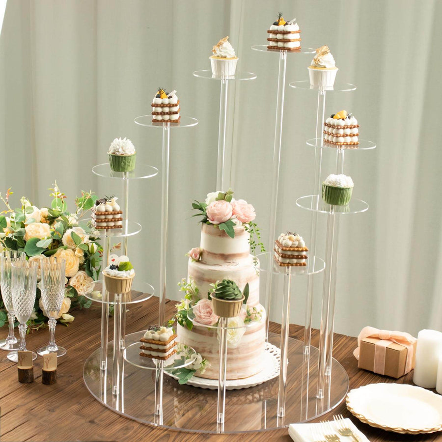 Elegant cake and cupcake display stand with assorted desserts and floral arrangements.