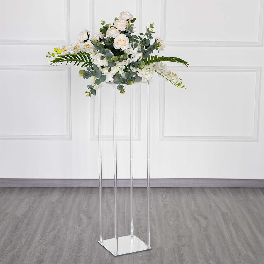 Elegant floral arrangement in a clear acrylic stand.