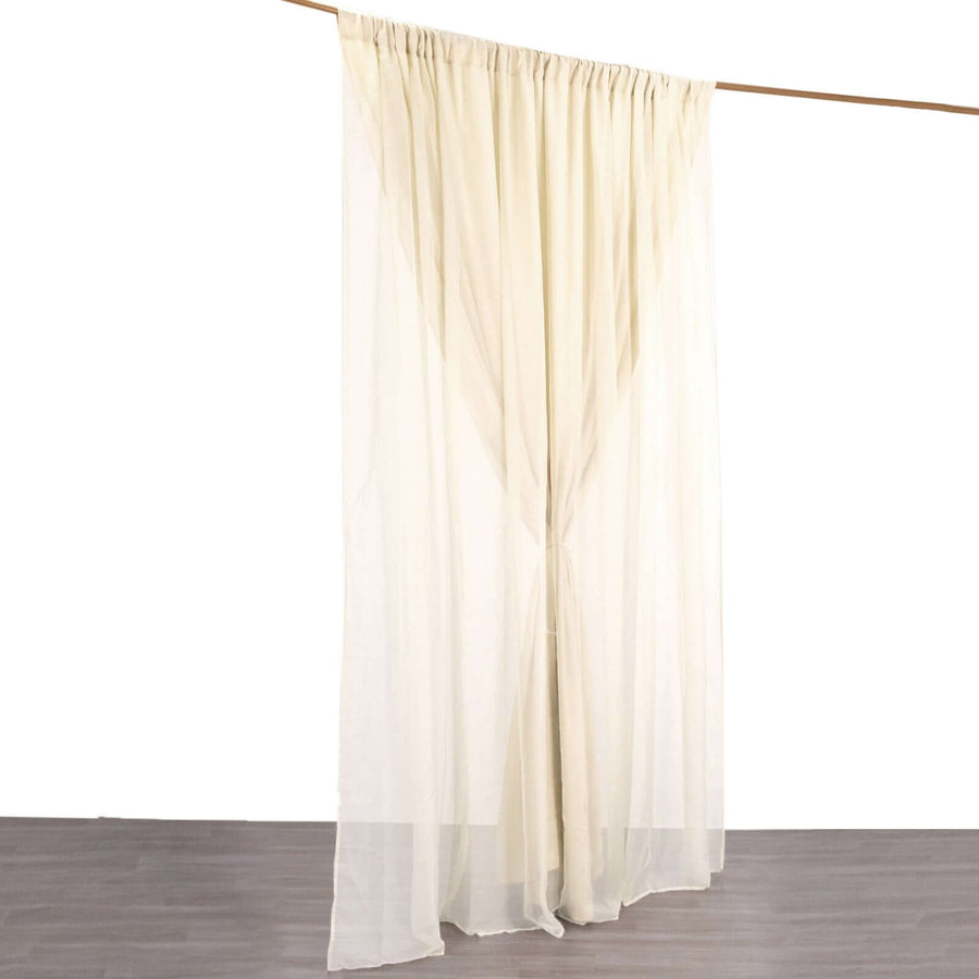 Sheer cream curtain panel hanging from a rod