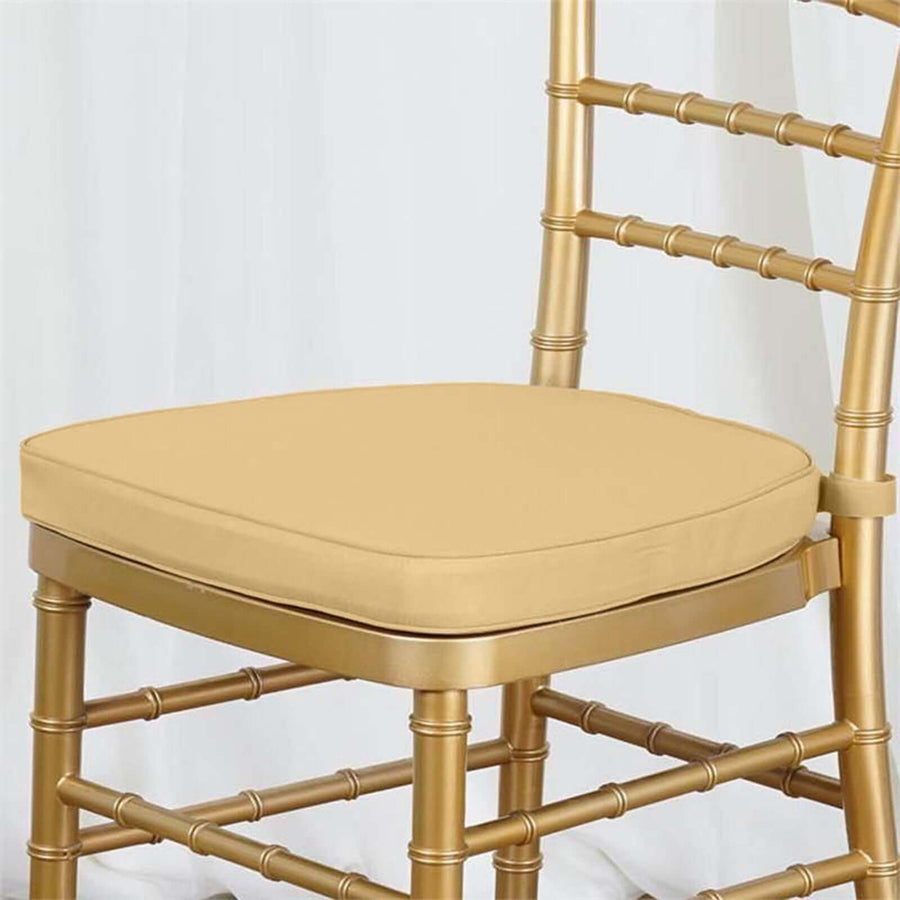Gold chiavari chair with a padded yellow seat cushion.