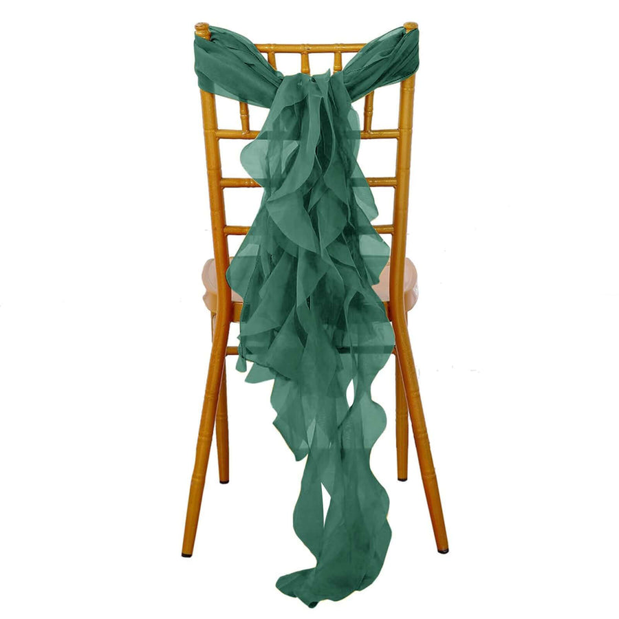 Green chiffon chair sash tied on a gold chiavari chair.