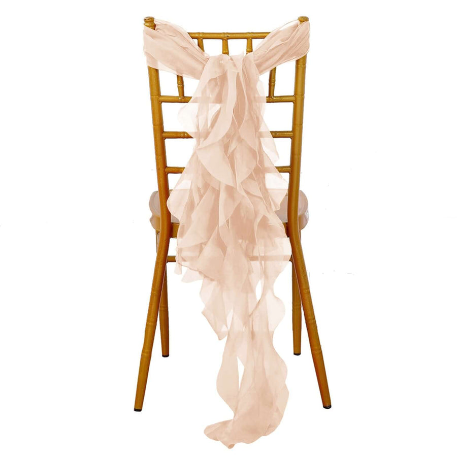 Pink chiffon chair sash draped over a gold chiavari chair.