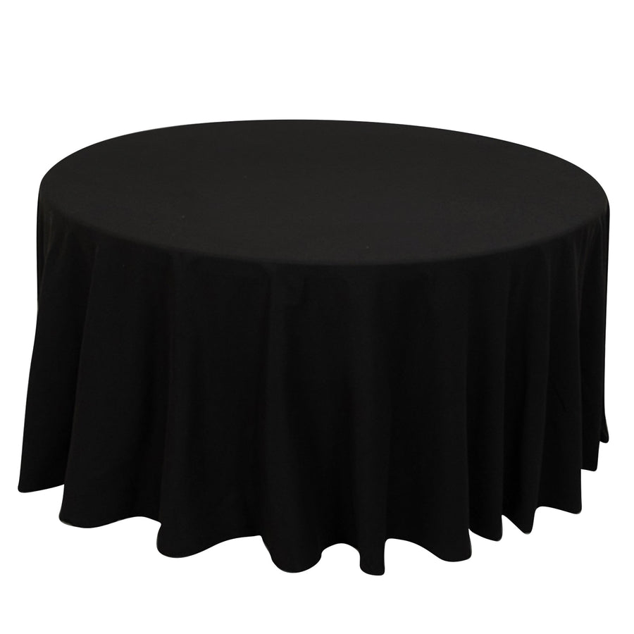 Round black tablecloth with elegant draping.