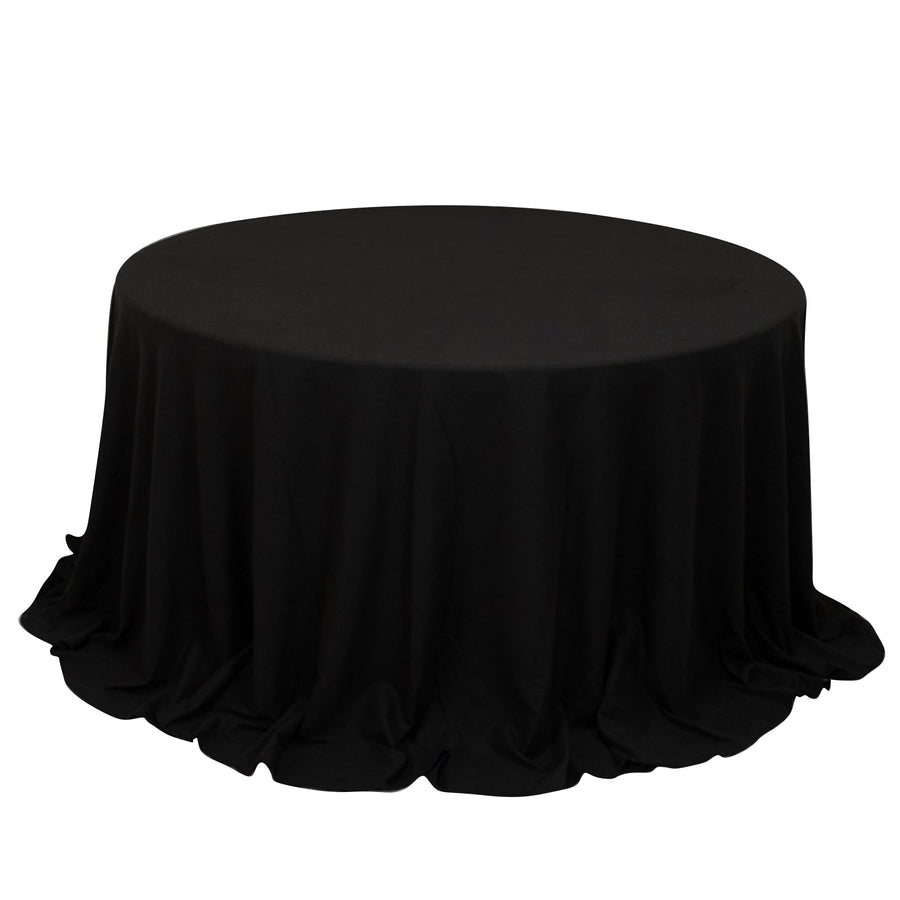 Black round tablecloth with elegant draping.