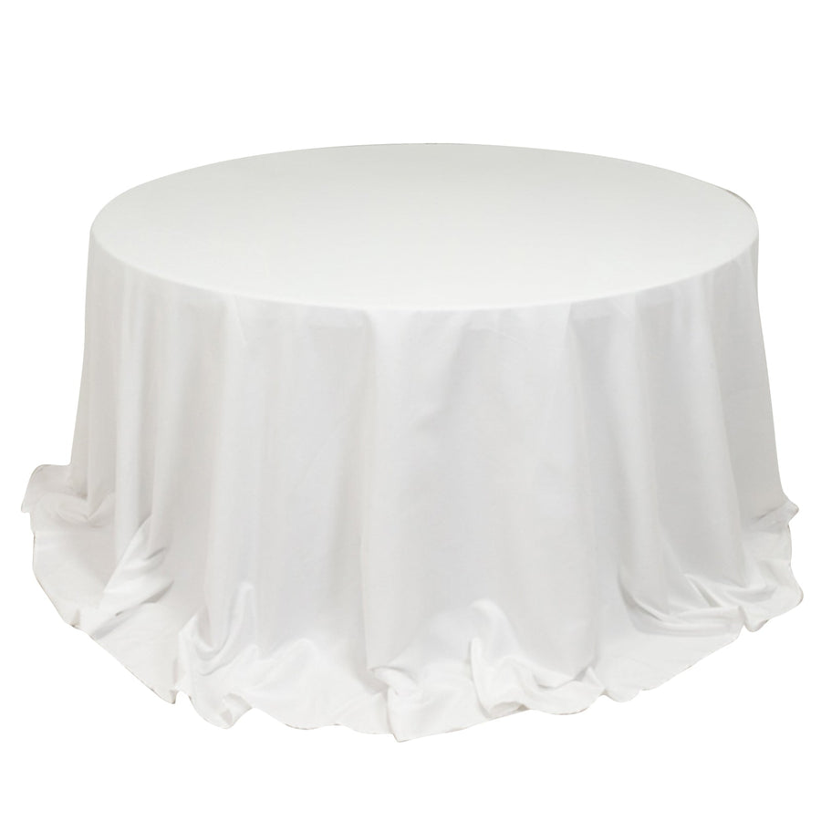 Round table with a white tablecloth draping elegantly.
