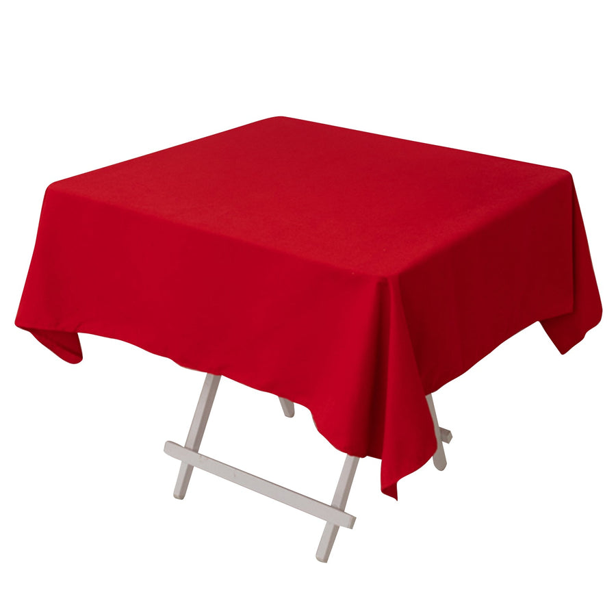 Red tablecloth draped over a folding table