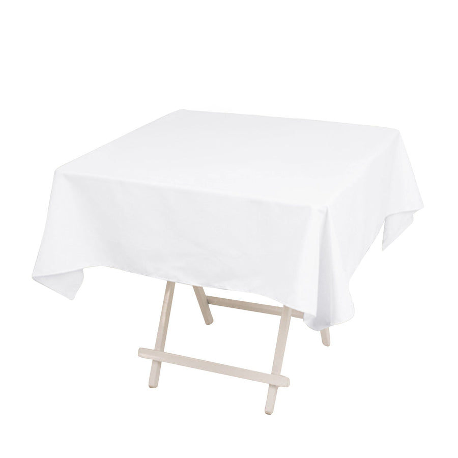 White tablecloth draped over a folding table in a studio-style isolation shot
